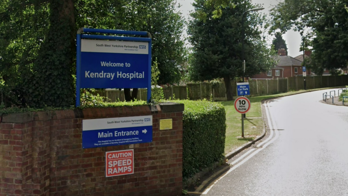 A blue sign with white writing reading "welcome to Kendray Hospital", with NHS branding.