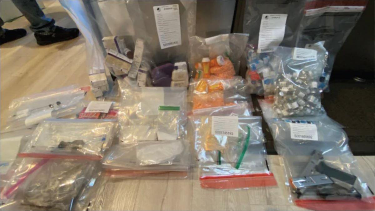 A photo taken by authorities shows various drugs in plastic bags, along with a handgun, that they say they found in Jasveen Sangha's home