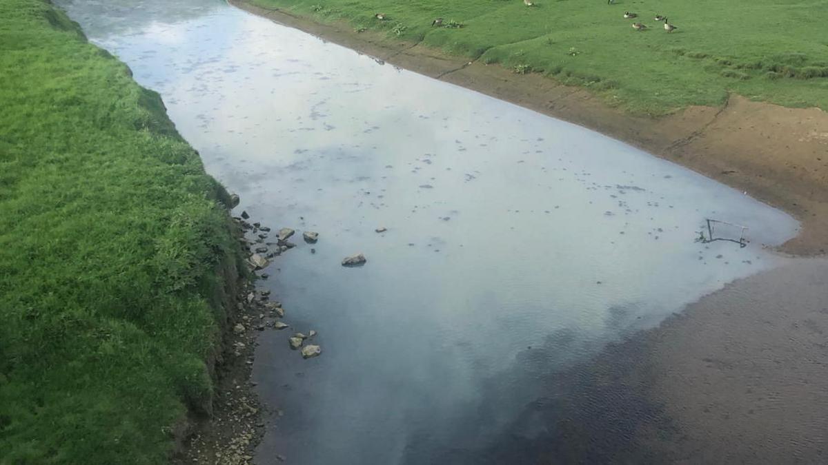 Discoloured water in the River Ogmore