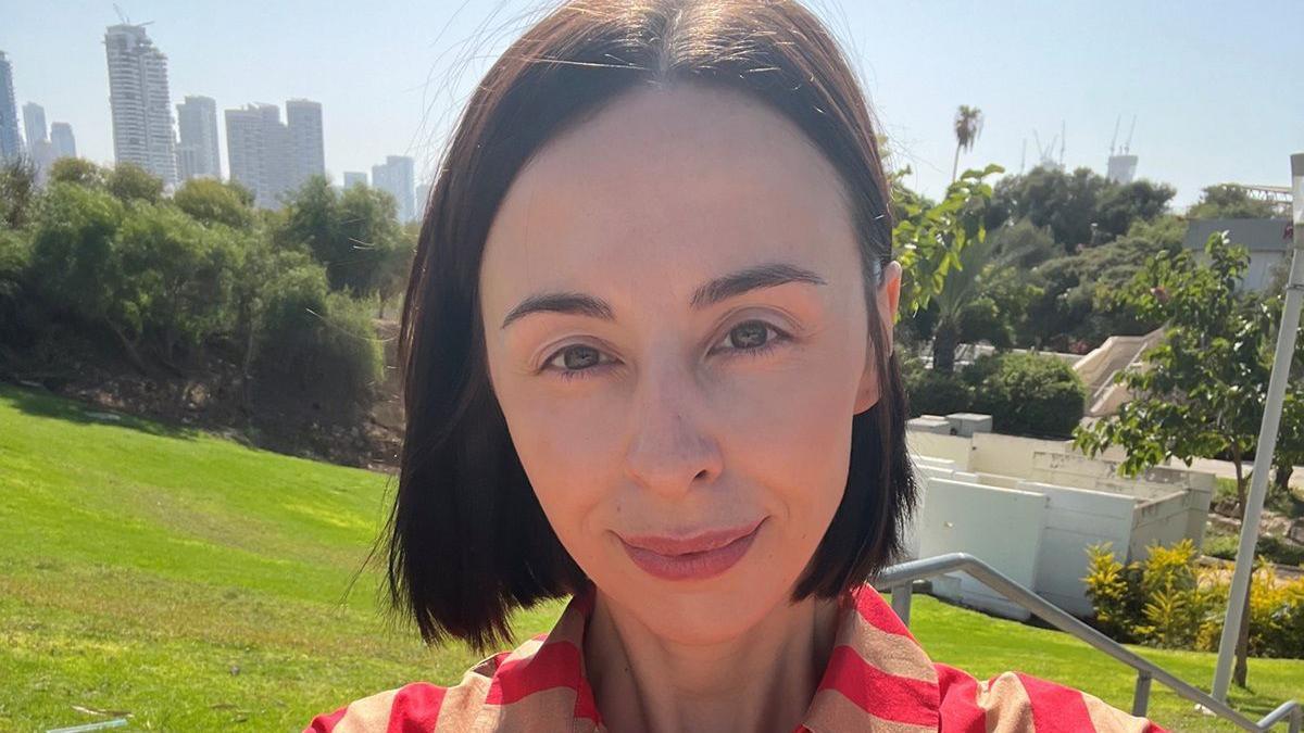 Selfie of  Dr Amy Williams, standing in an urban park