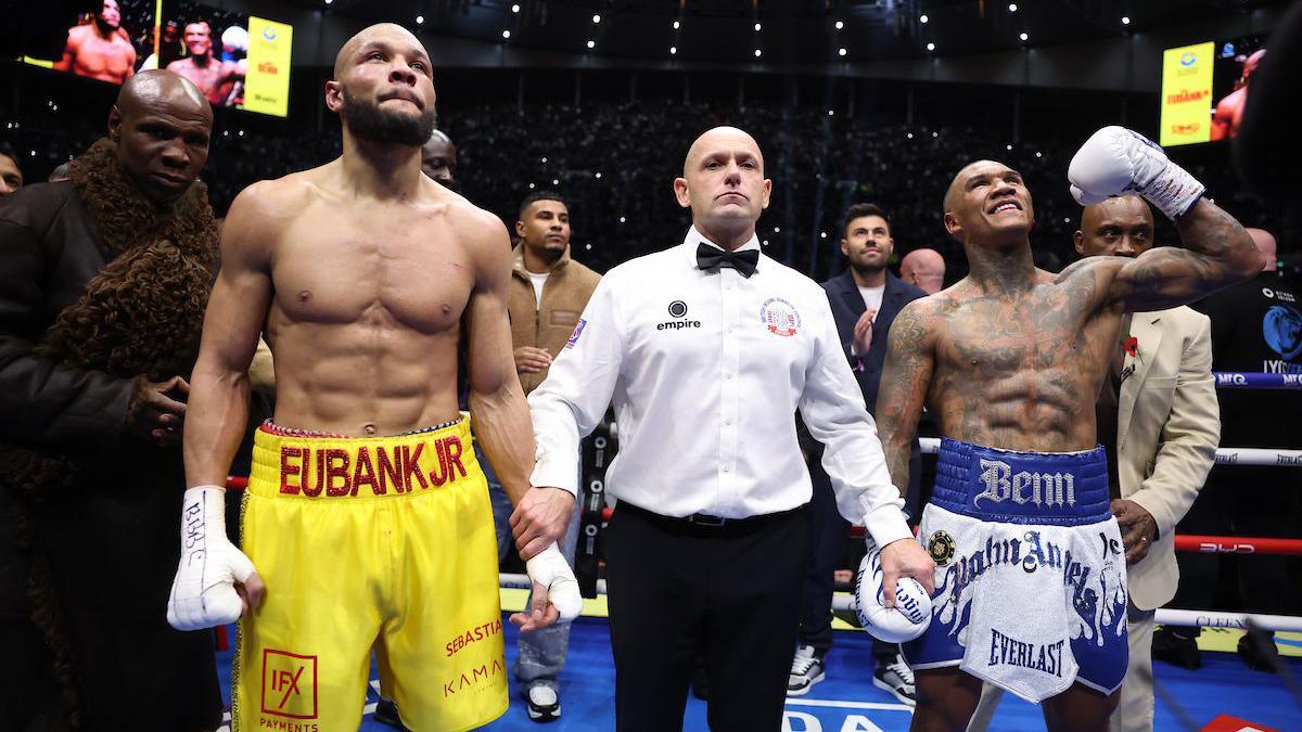 Conor Benn celebrates and Chris Eubank Jr looks up with the referee in the middle following the conclusion of their rematch