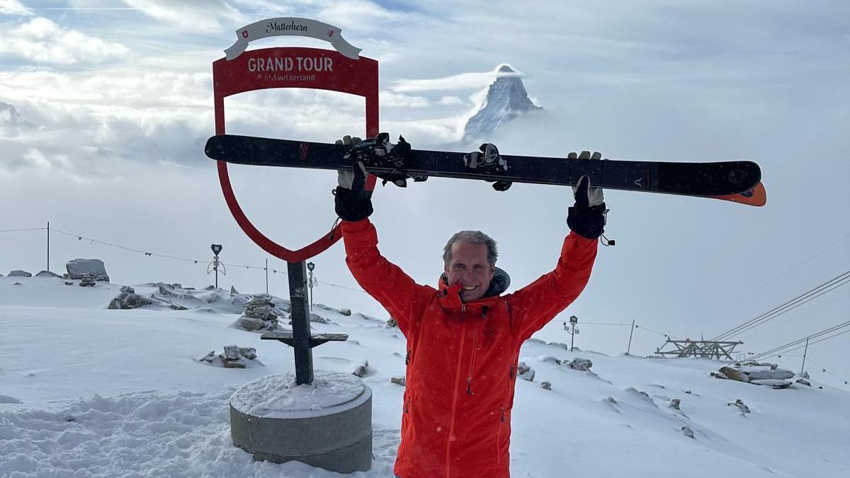 John dressed in a red coat, pictured on a skiing trip to Switzerland