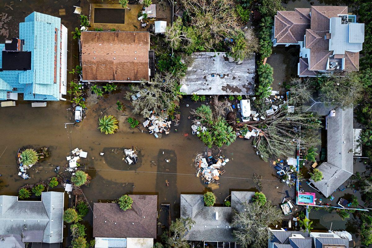 A drone image shows a flooded street with houses and trees felled, due to Hurricane Milton in Siesta Key, Florida, on October 10, 2024