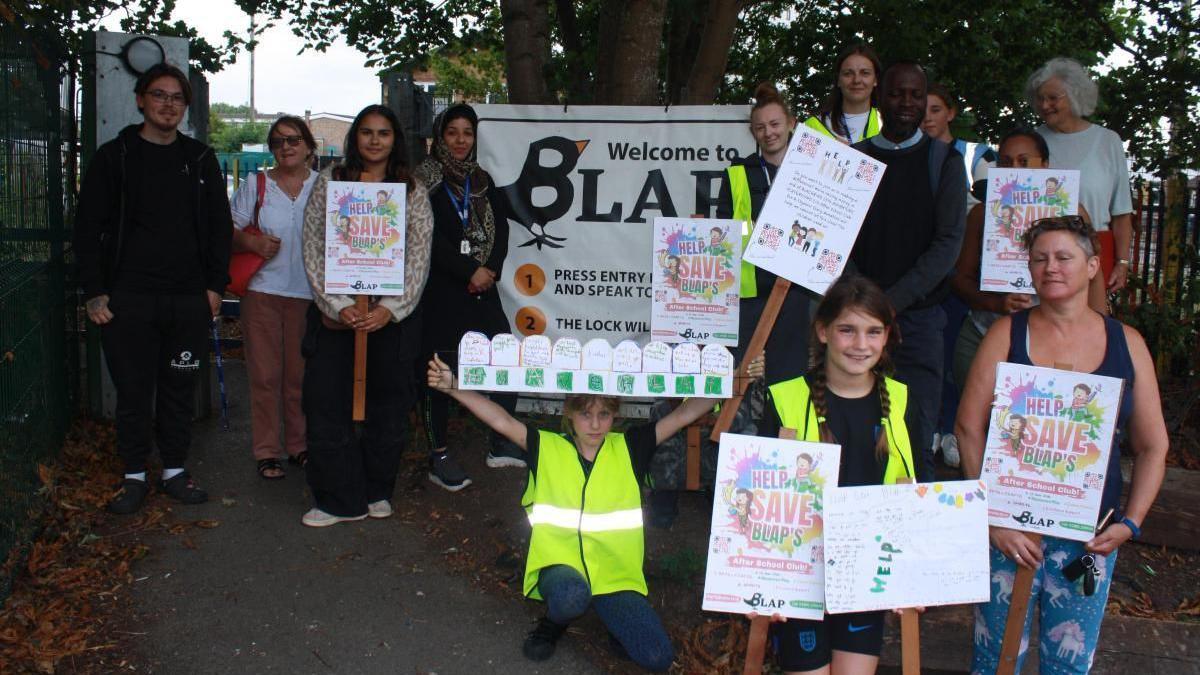Campaigners raising awareness for the playground holding signs.