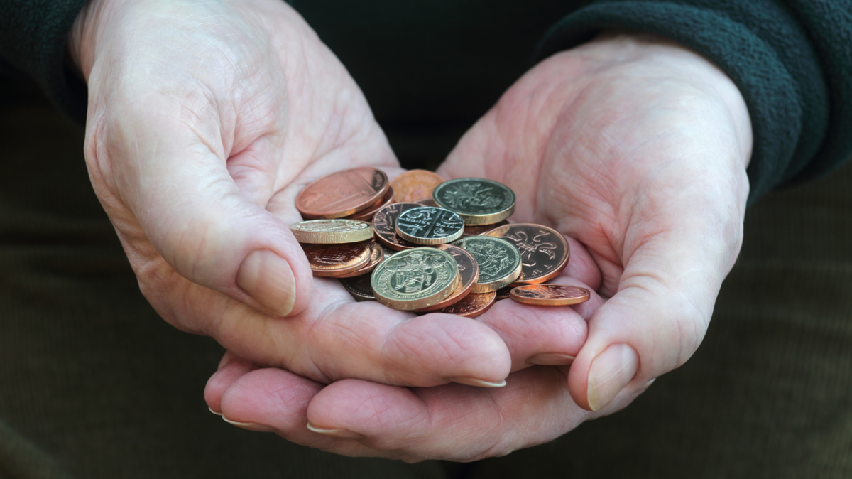 Man holding British coins