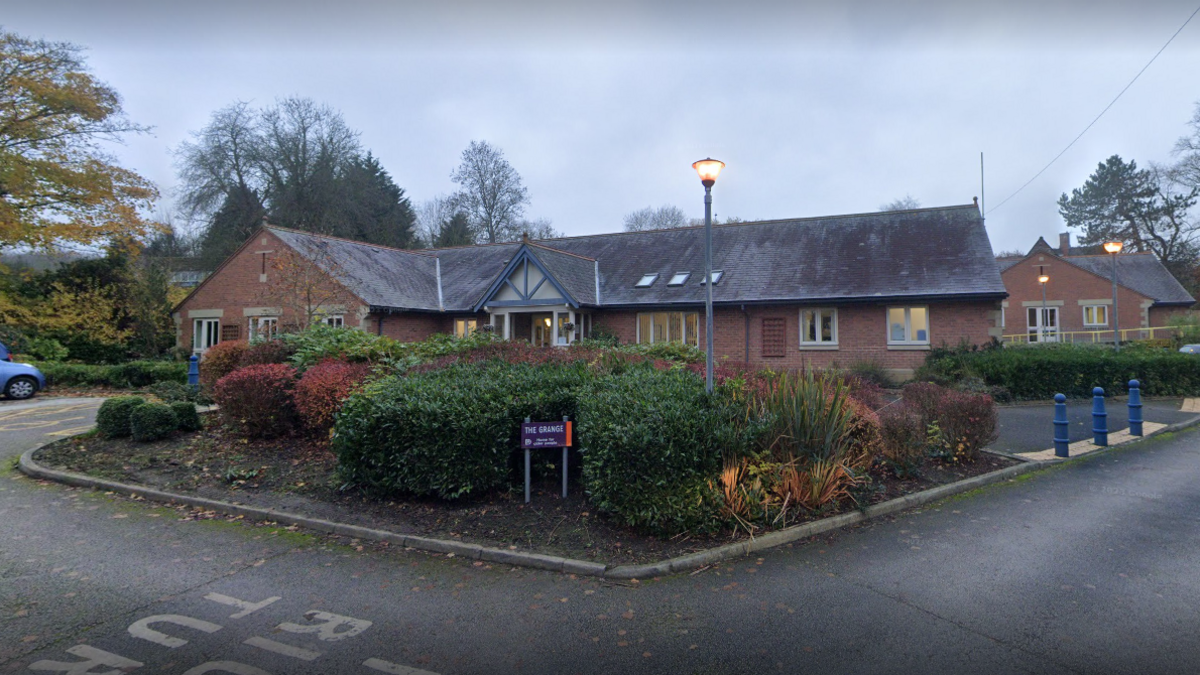 The Grange Care Home in Eckington, North East Derbyshire. Brick building with grey roof and shrubbery infront 