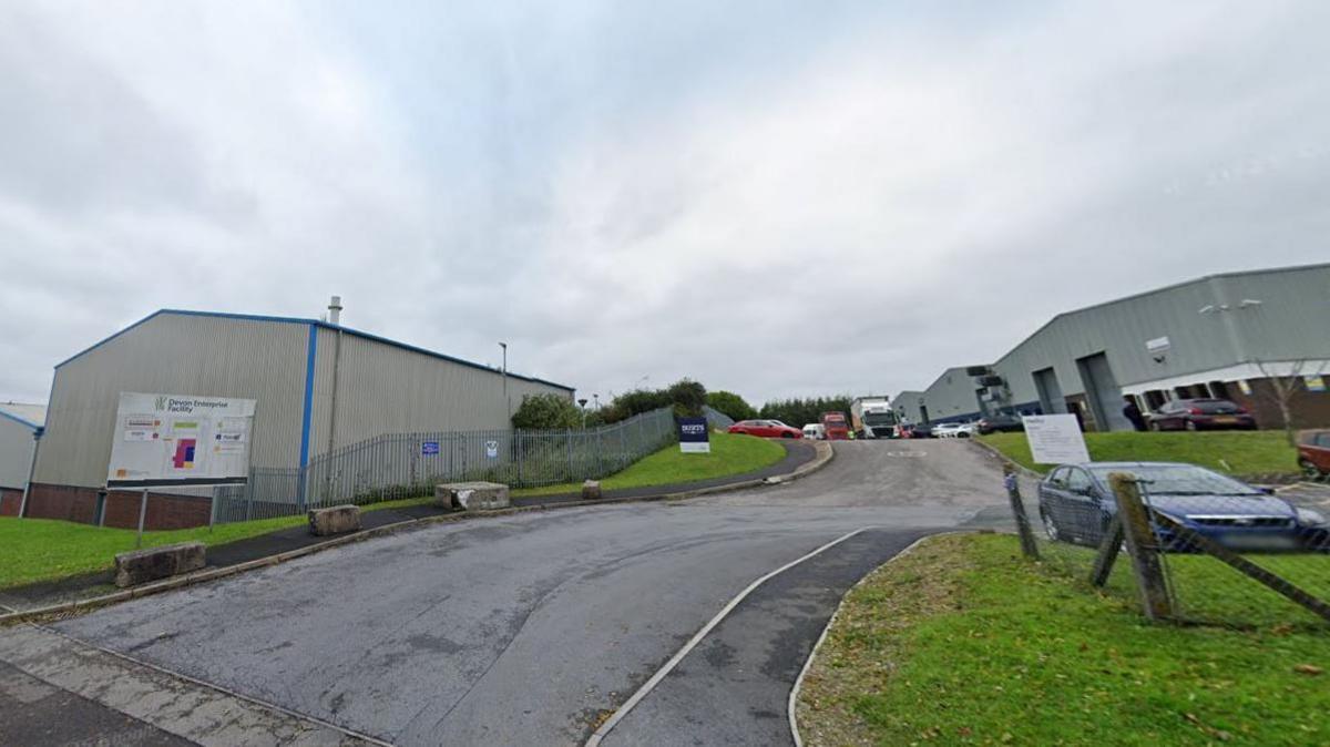 A view of part of the industrial estate showing warehouses, roads and parked cars.