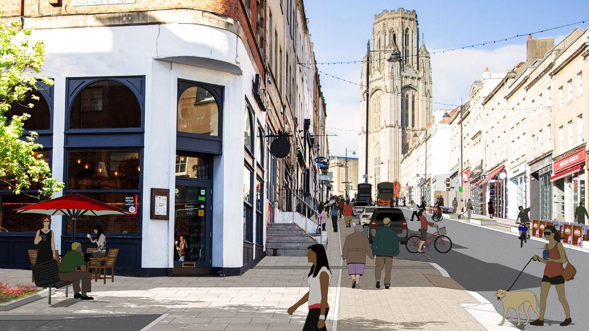 An artist's impression of what Park Street could look like. It shows the corner of a restaurant with outdoor seating, people walking across the road and wider pavements. The Wills Memorial Building is visible in the background at the top of the hill.