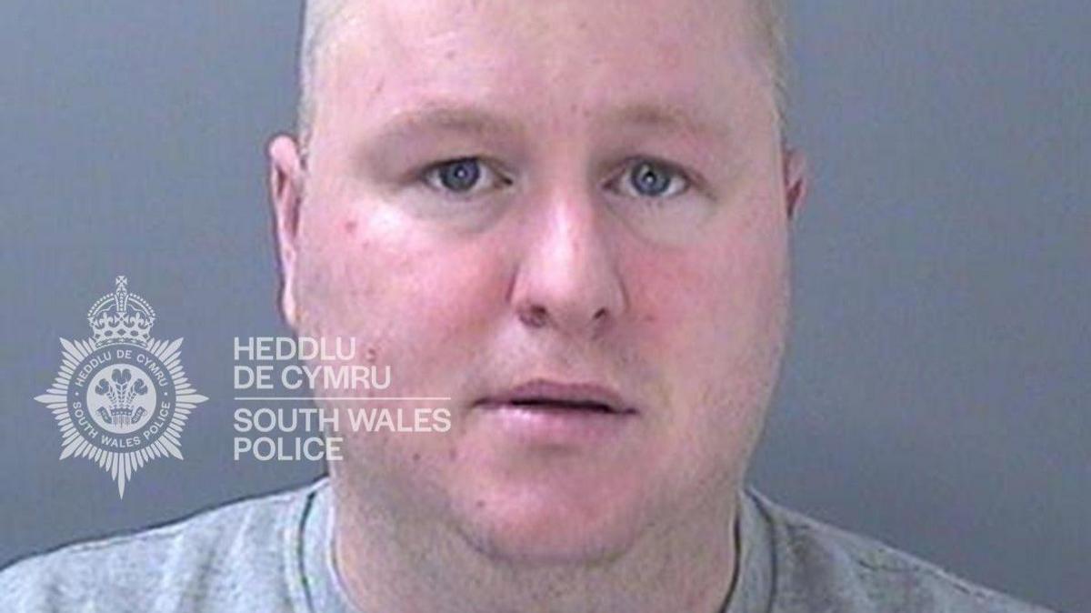 Former Bridgend town councillor Darren Brown mugshot. He is wearing a grey jumper