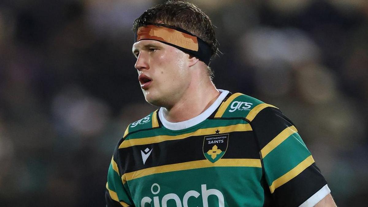 Archie Benson, wearing a headband, playing for Northampton Saints