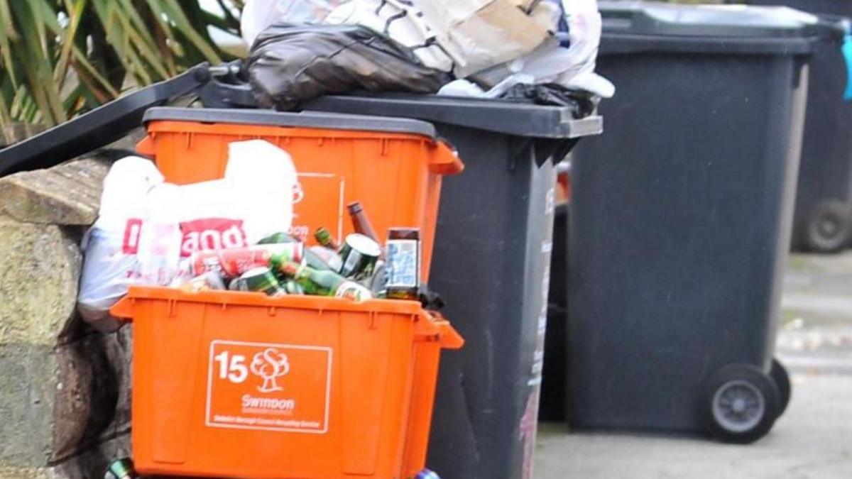 A picture of bins on a street pavement