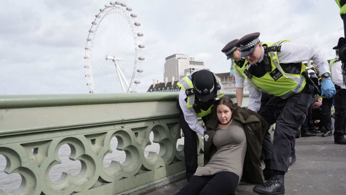 Police remove a protester after a banner was unfurled on Westminster Bridge 