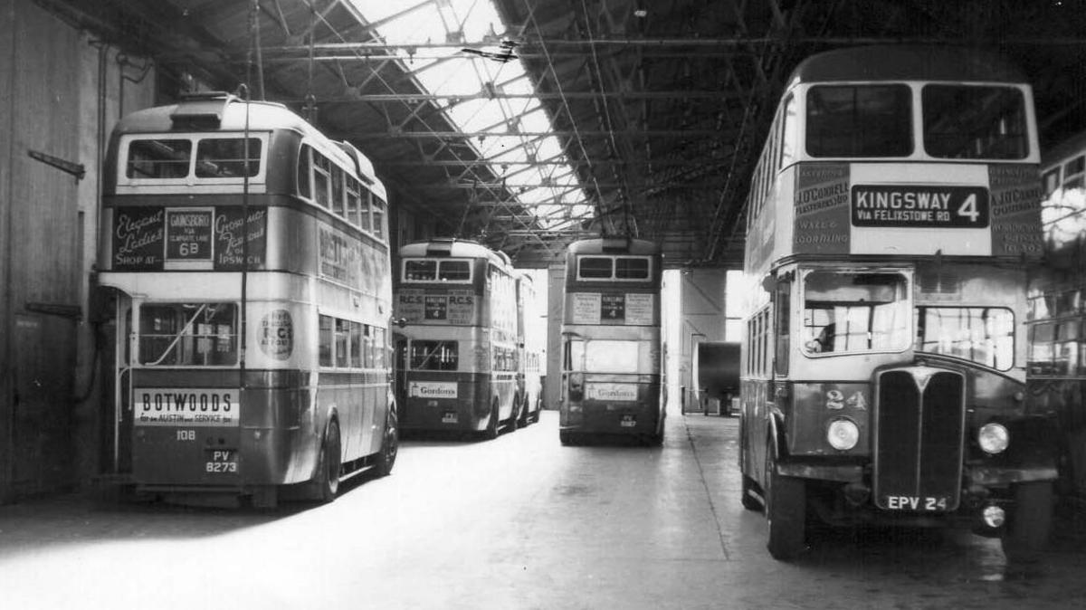 This is a black and white photograph dating back to the 1950s showing five double decker buses parked in a depot.