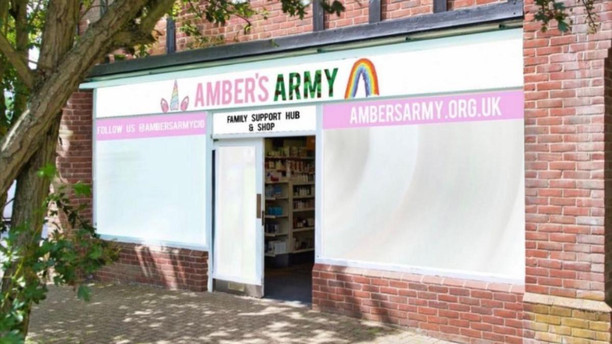 A mock up of a shop front, with Amber's Army signage. 