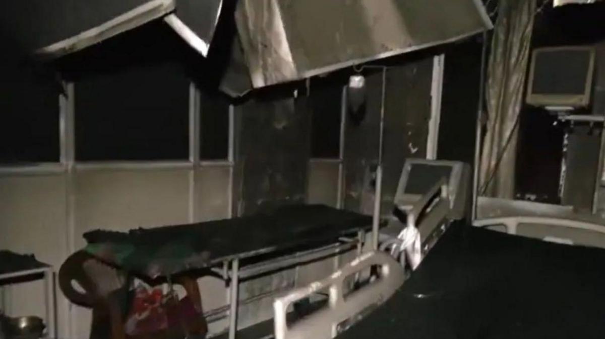 A charred hospital room with two beds, monitors and some broken equipment hanging from above after the fire incident on 5 October