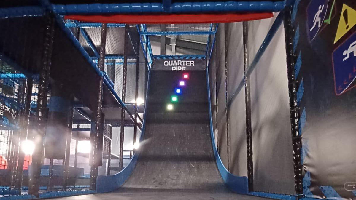 A sloped surface inside the arena with a variety of coloured markers at the top