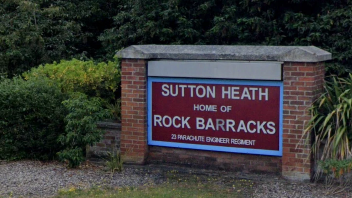 A large sign which reads Sutton Heath home of Rock Barracks