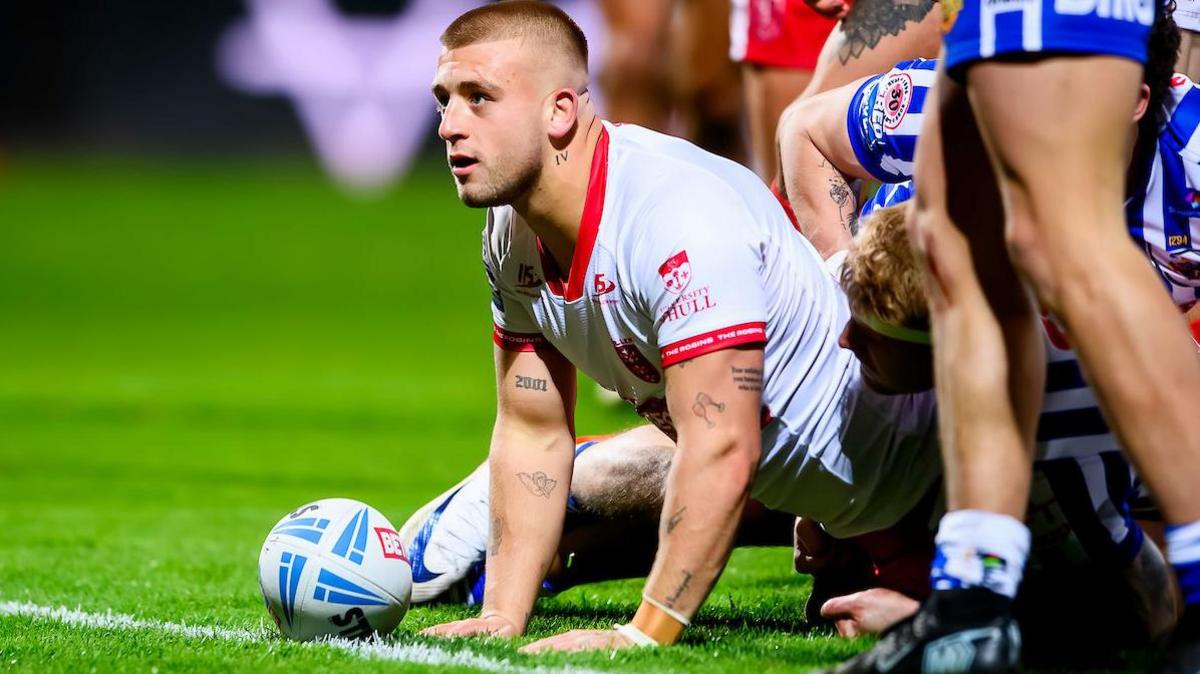Hull KR half-back Mikey Lewis scoring a try against St Helens and looking up towards the crowd in celebration with the ball still on the whitewash.