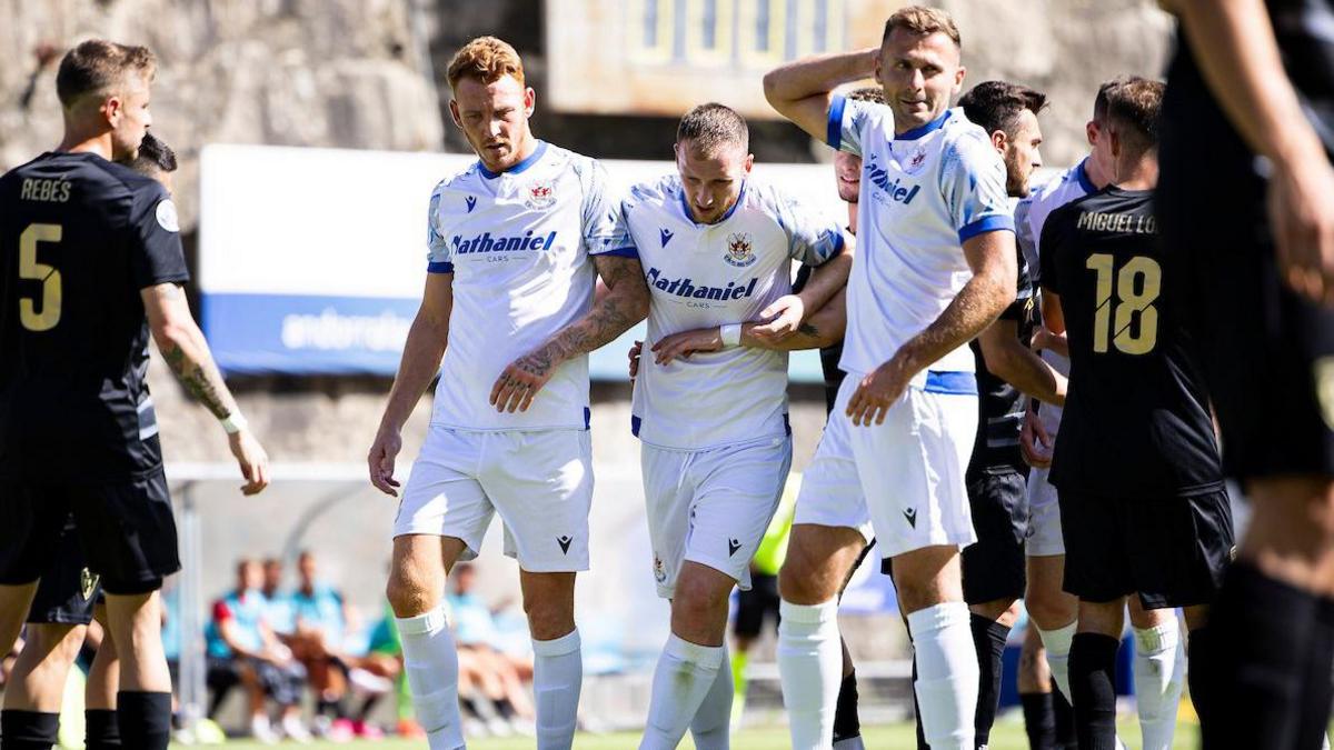 Three Penybont players in white away kits in the game in Andorra