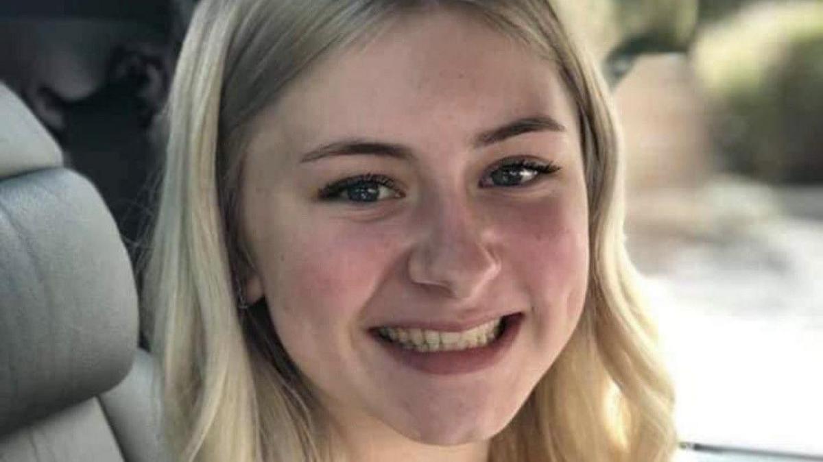 Laionie Kennard, with long blonde hair, smiling at the camera, sitting in a car