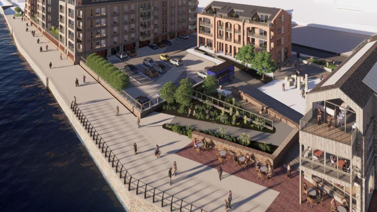 An architect's drawing of the wharf viewed from above. The river is high and there is a broad walkway along the side of it which has people walking along it. There is a public square which has trees, planters, tables and chairs. There is a small car park. The buildings are a mixture of styles. The ones in the foreground and centre look like they have a warehouse design while the ones further along the river are at least five storeys high.