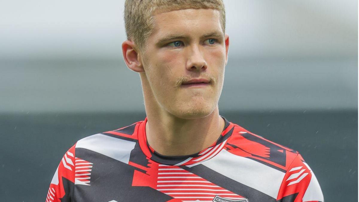 Grimsby Town forward Cameron Gardner warms up