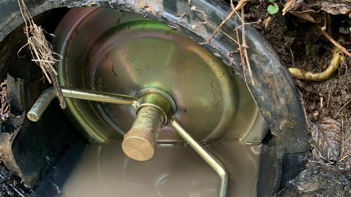 A brass plug covers an outlet pipe