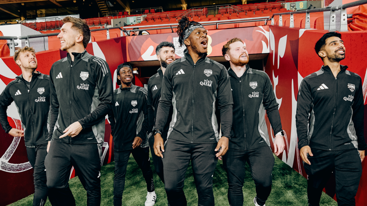 The Sidemen group walking out on the Wembley Stadium football pitch