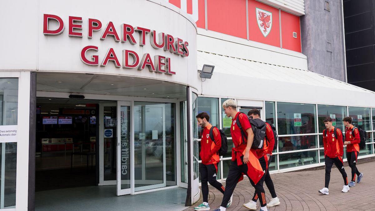Wales players enter the departures at Cardiff airport
