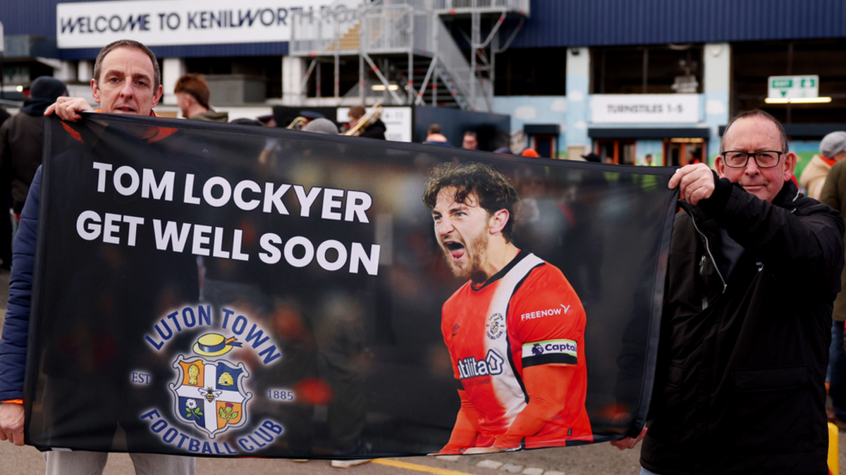 Luton fans hold up a banner in support of player Tom Lockyer after he suffered a cardiac arrest