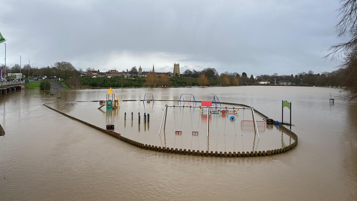 Children's playground surrounded by flood water in Evesham