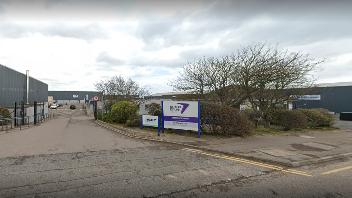 North East Scotland College (NESCol) sign and building, with trees and road visible.