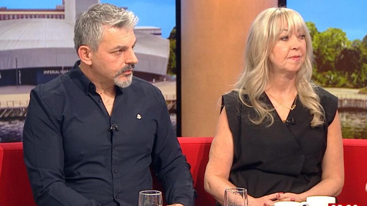 Andrew and Lisa Roussos are sitting side by side on the BBC Breakfast red sofa. They are both looking towards the interviewer as they answer questions about the new book.