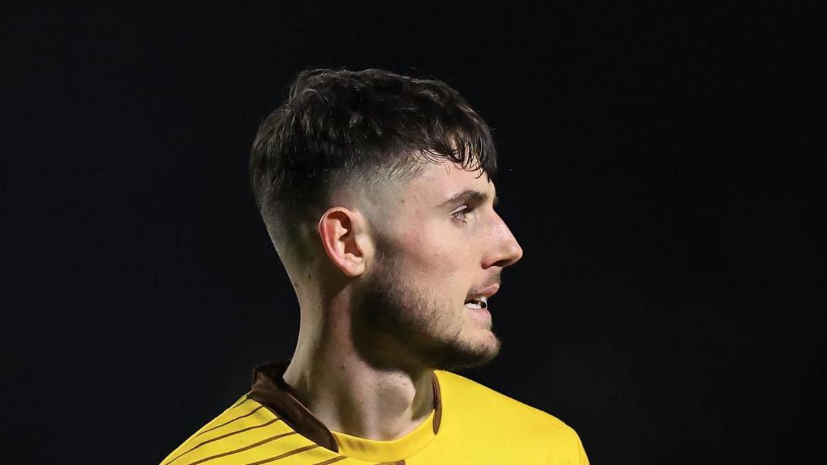 Striker Olly Sanderson playing for Sutton