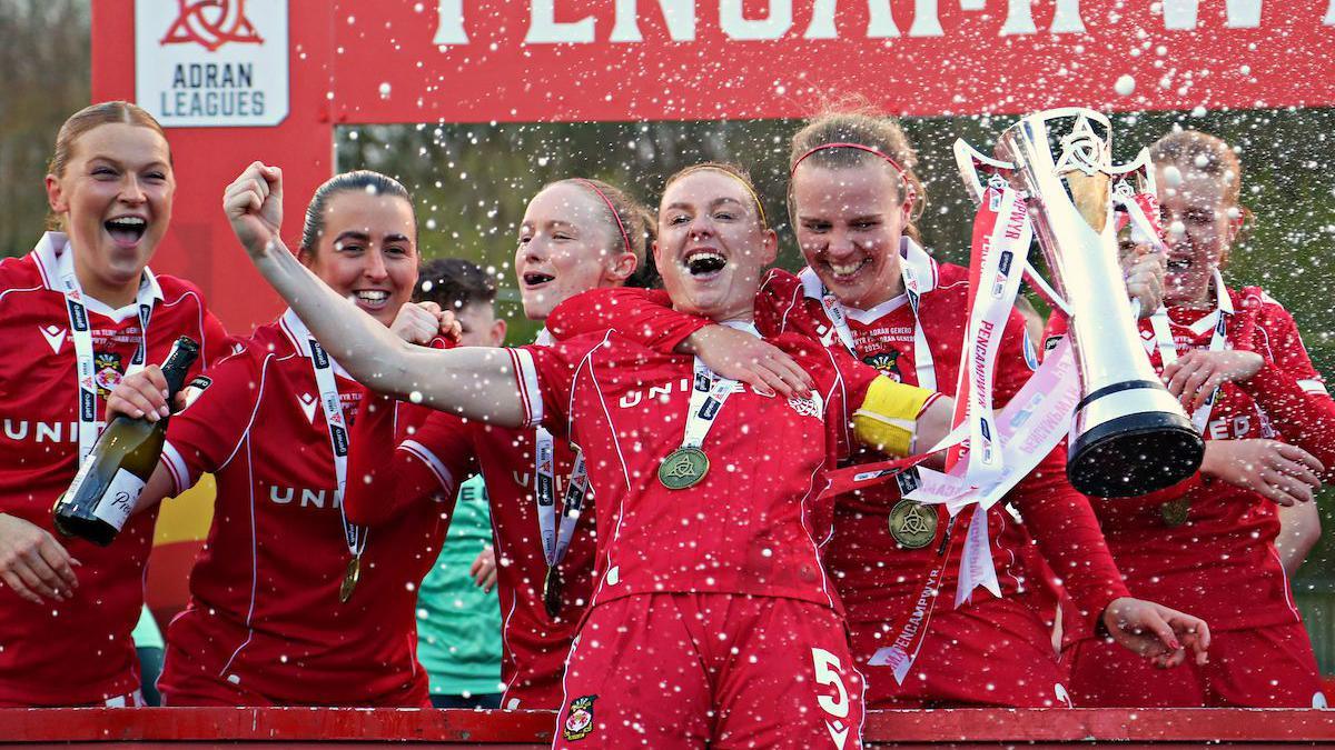 Wrexham players celebrate with Adran Premier trophy