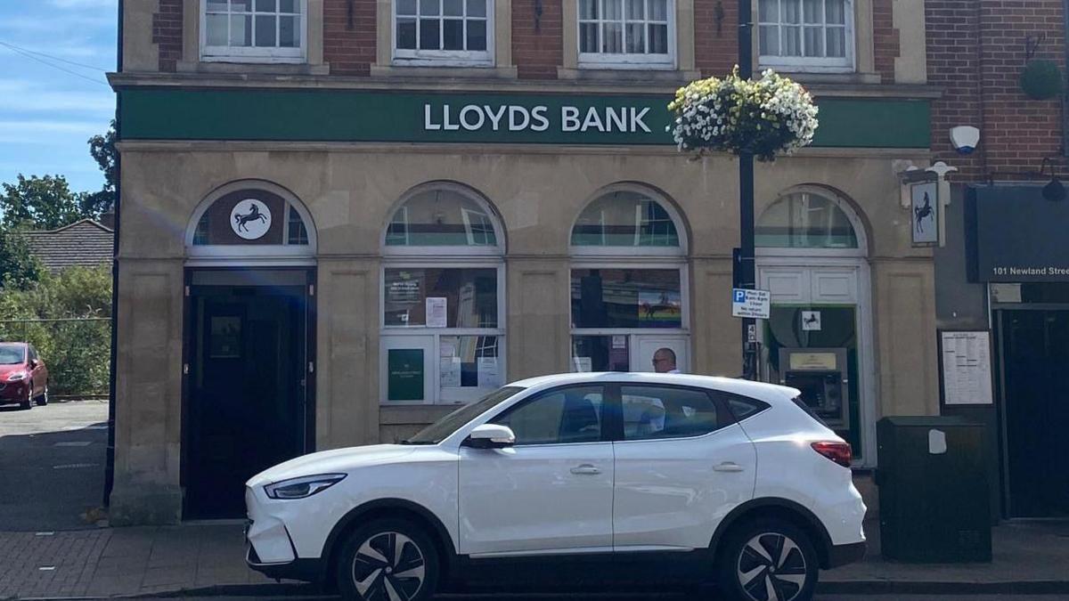 A white car parked outside Lloyds Bank in Witham