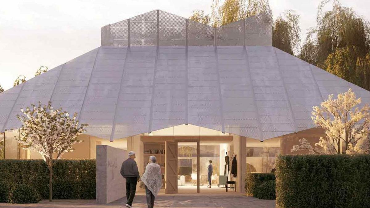 Large dome-shaped building made of panels with two people walking towards the entrance