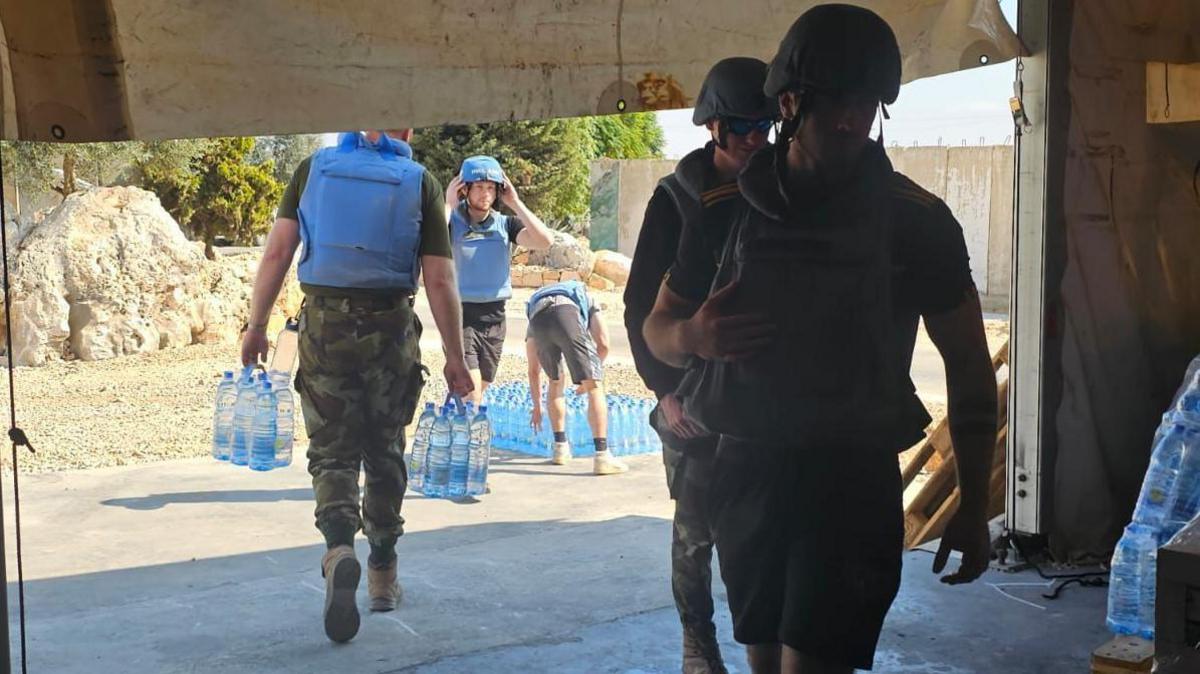 Irish defence force soldiers carrying water into a building in southern Lebanon