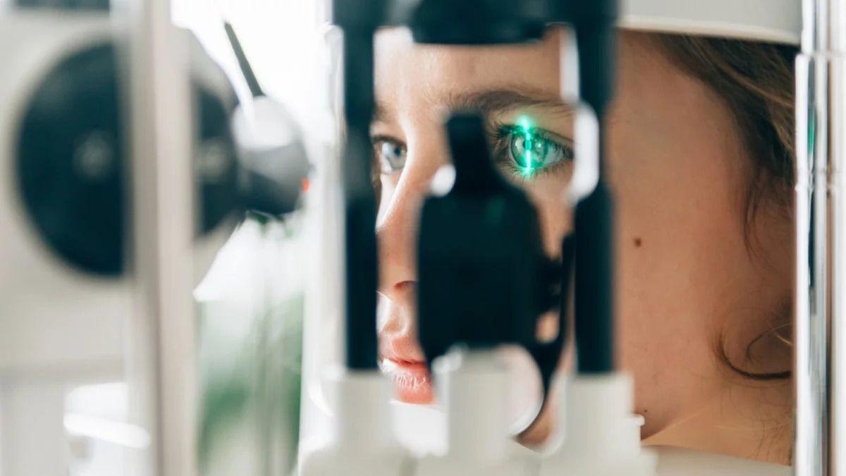 Close up of a young person's face with an eye being examined by technical equipment
