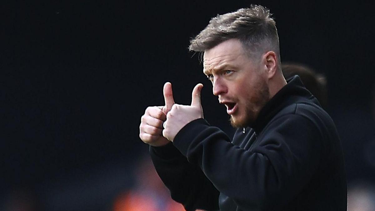 Kim Hellberg gives a double thumbs up on the Boro sideline