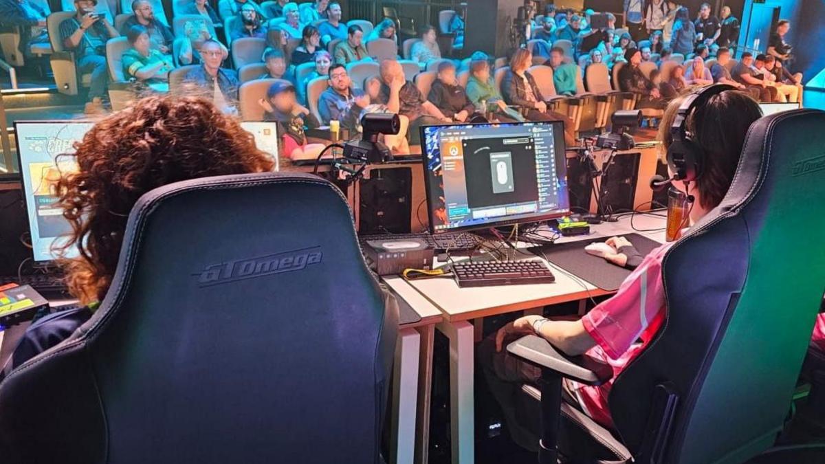 Three players participating in a esports game for spectators.