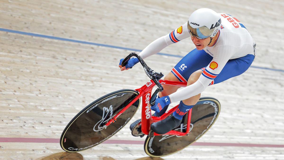 Will Bjergfelt races around the track while wearing his Great Britain skinsuit and kit