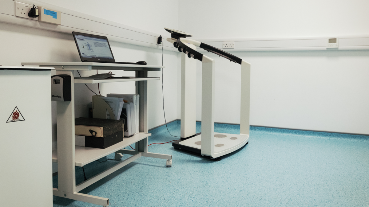 The main body scanner in a room at the hospital. It appears to be connected to an open laptop.