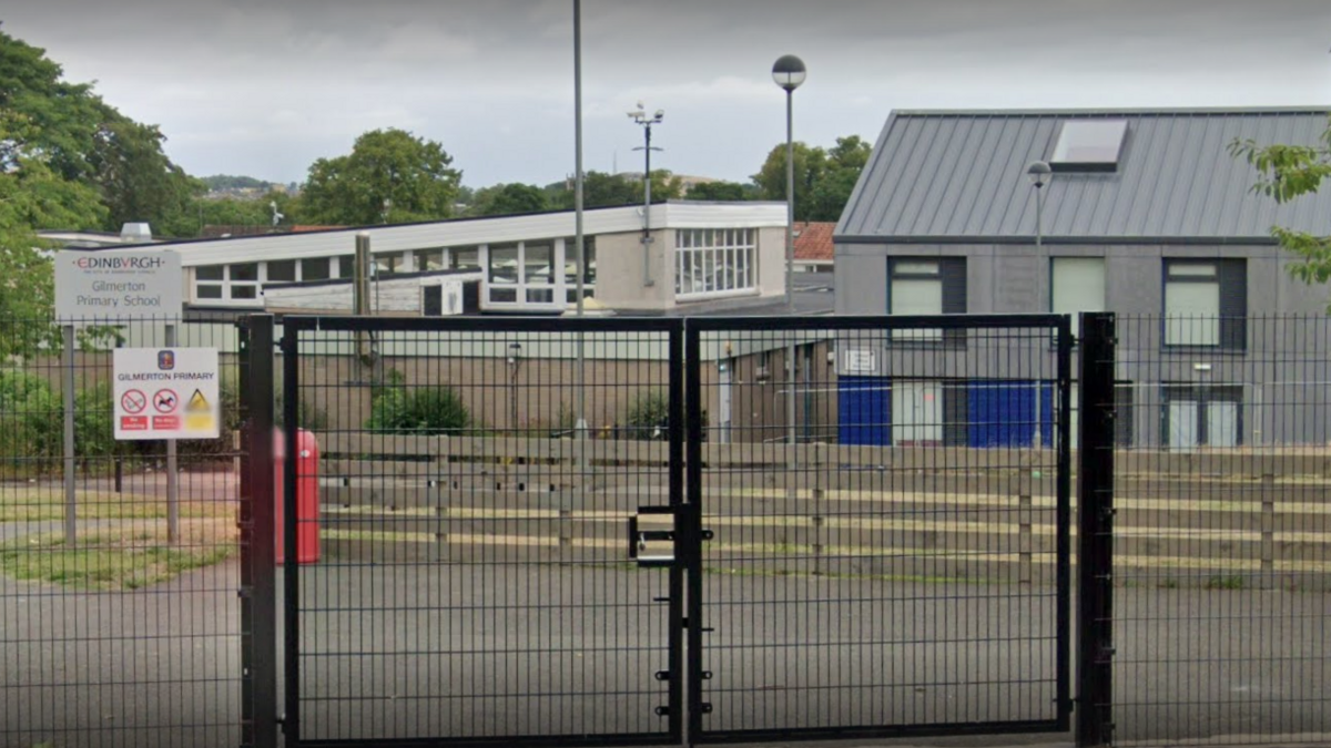 A google image of the front of Gilmerton Primary School behind black gates