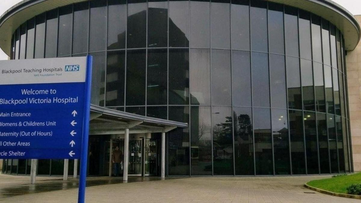 Exterior of Blackpool Victoria Hospital main entrance. It is a large glass-fronted building.