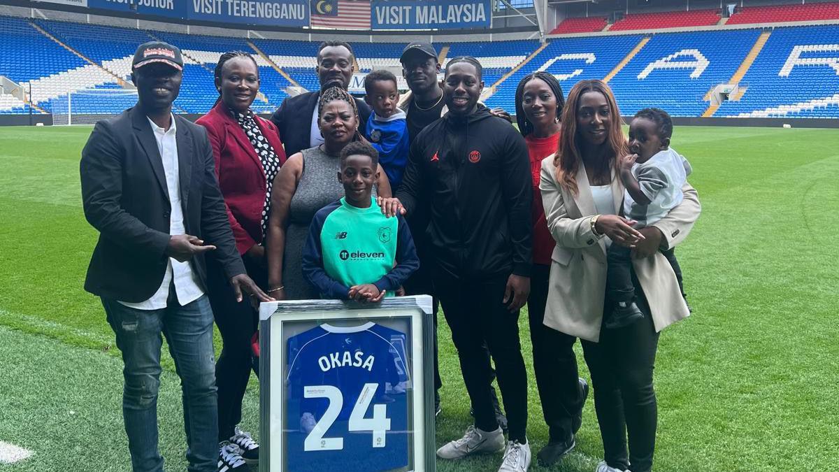 Calvin and family stand in Cardiff City FC