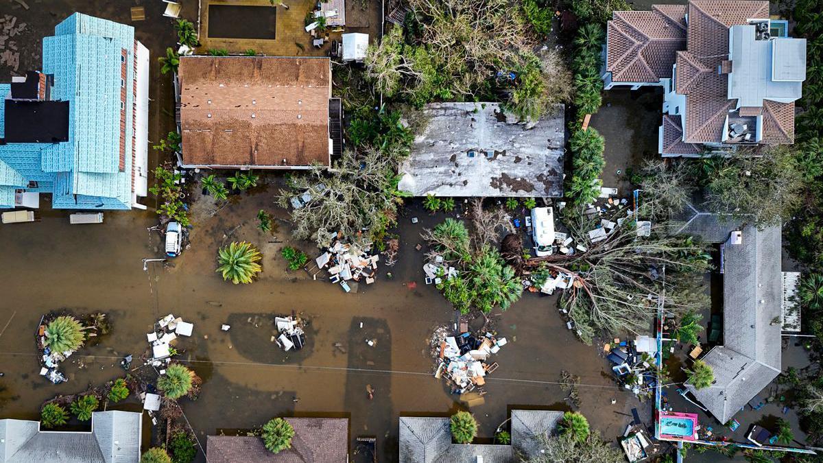 A drone image shows a flooded street with houses and trees felled, due to Hurricane Milton in Siesta Key, Florida, on October 10, 2024