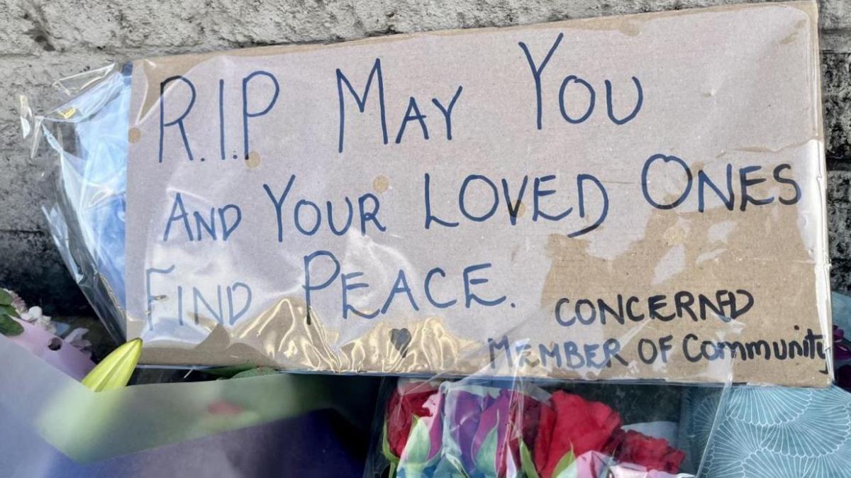 A sign next to flowers left outside Legacy's Hull branch, which reads: "RIP may your loved ones find peace. Concerned member of community."