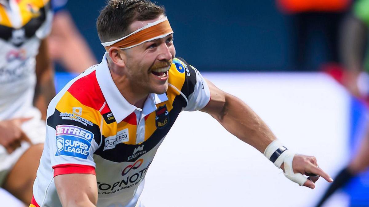 Chris Atkin celebrates scoring a try for Bradford Bulls