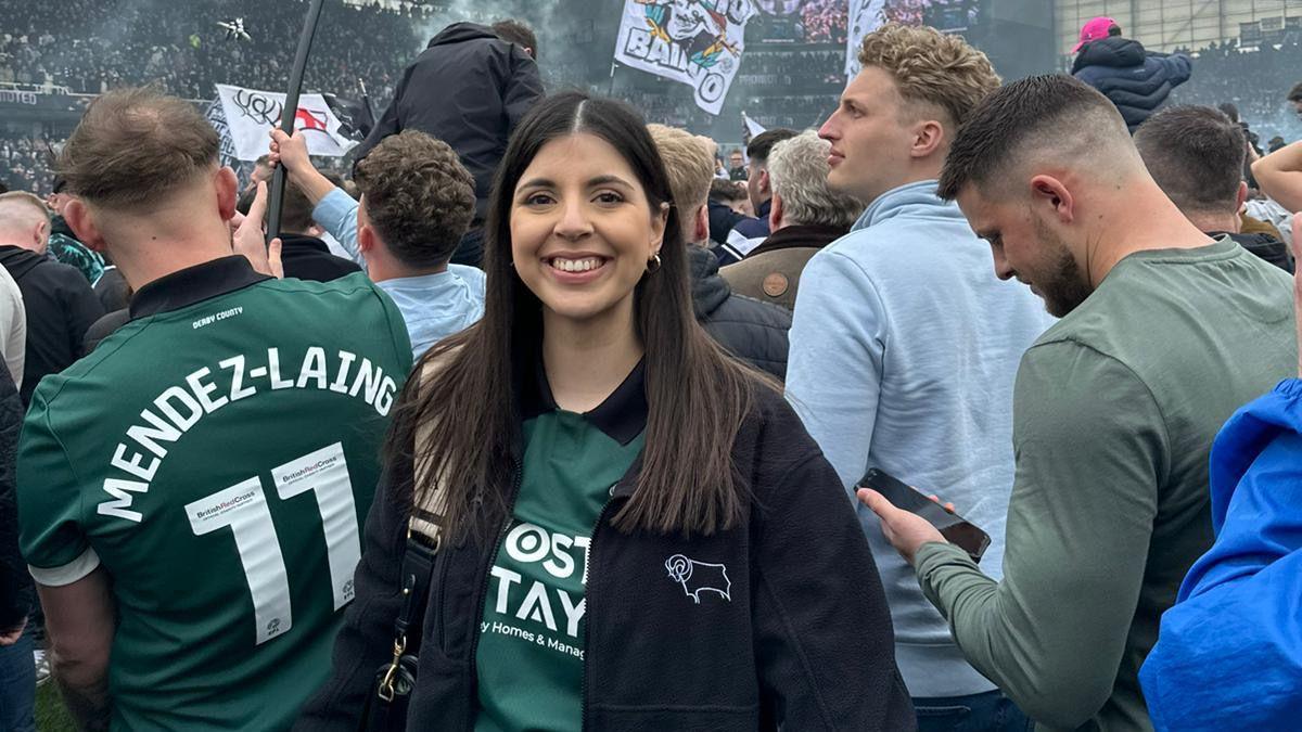 A photo of Simran Atwal wearing a green Derby County shirt on the pitch at Pride Park Stadium 